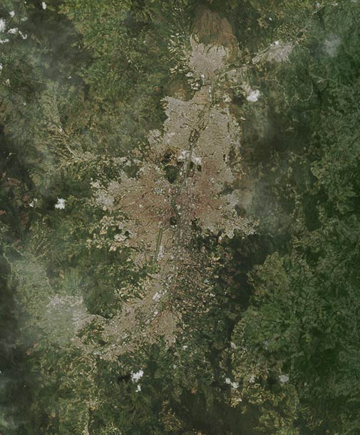 Zoomed out satellite image of Medellín and the surrounding green Aburrá Valley.