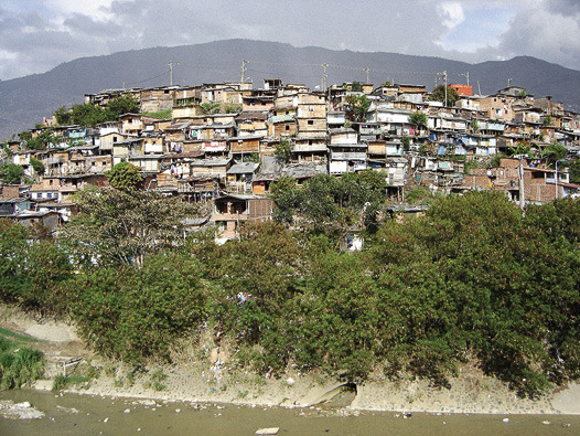 Buildings lining a hill in an informal squatter settlement. In ten years Medellín doubled its population.