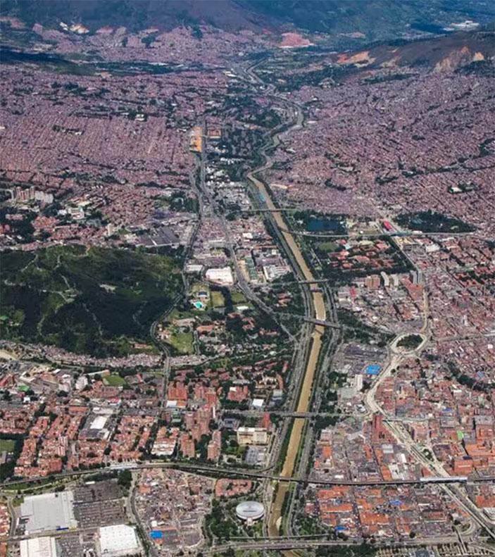 Birds eye view looking down at the valley and city grid of Medellín.