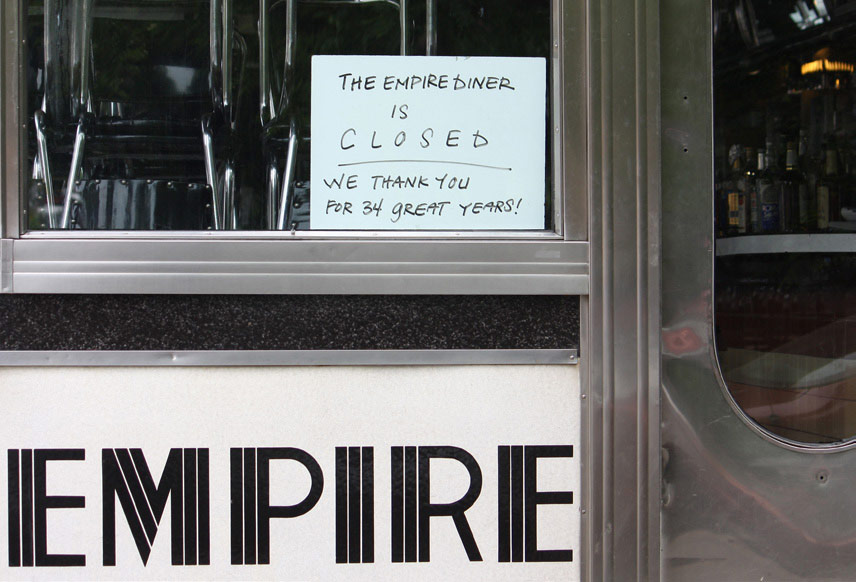 Sign in the window of the Empire Diner reading "The Empire Diner is closed – we thank you for 34 great years!"